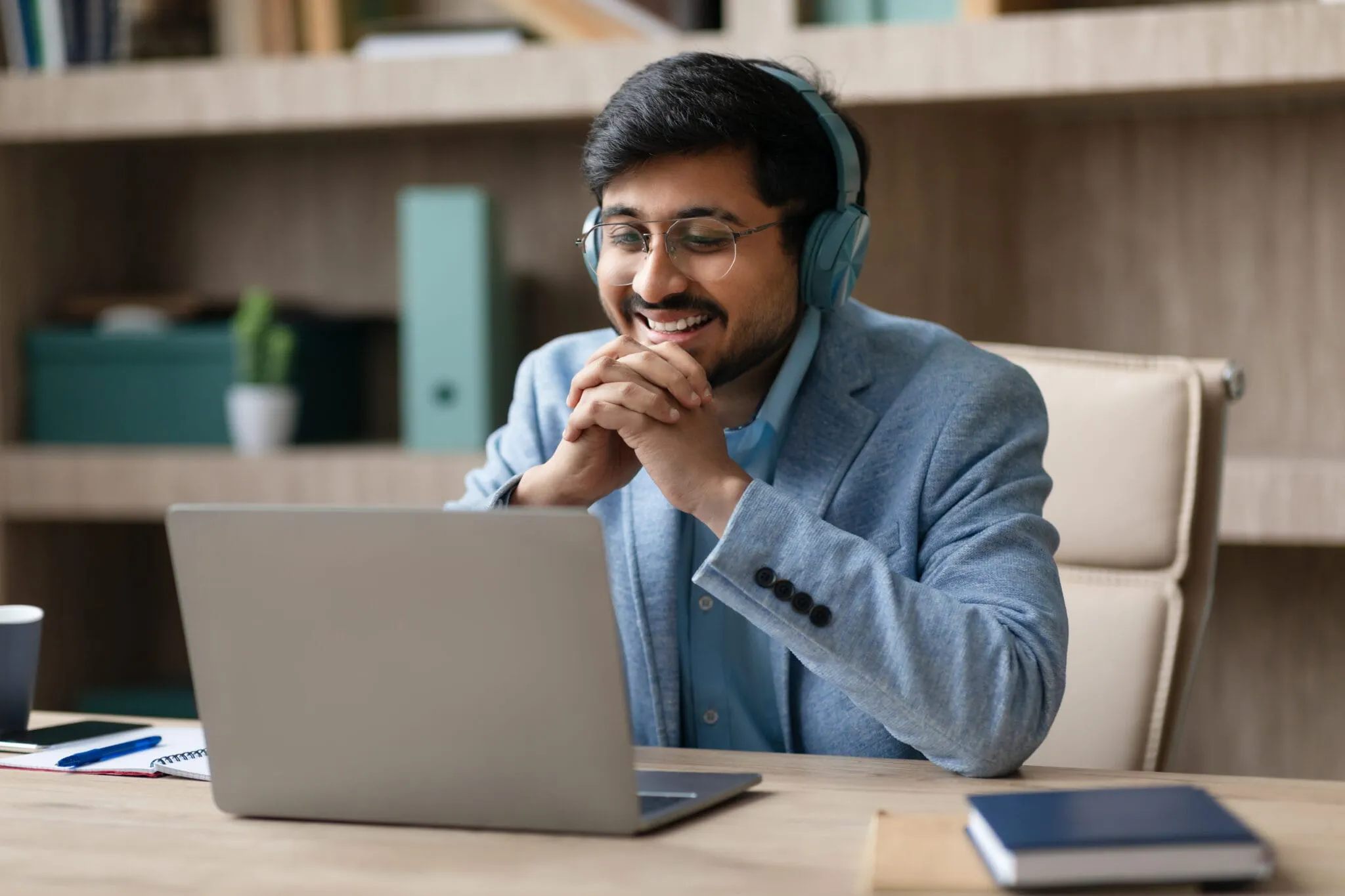 manager-wearing-earphones-engaged-in-video-call-image-unified-voice