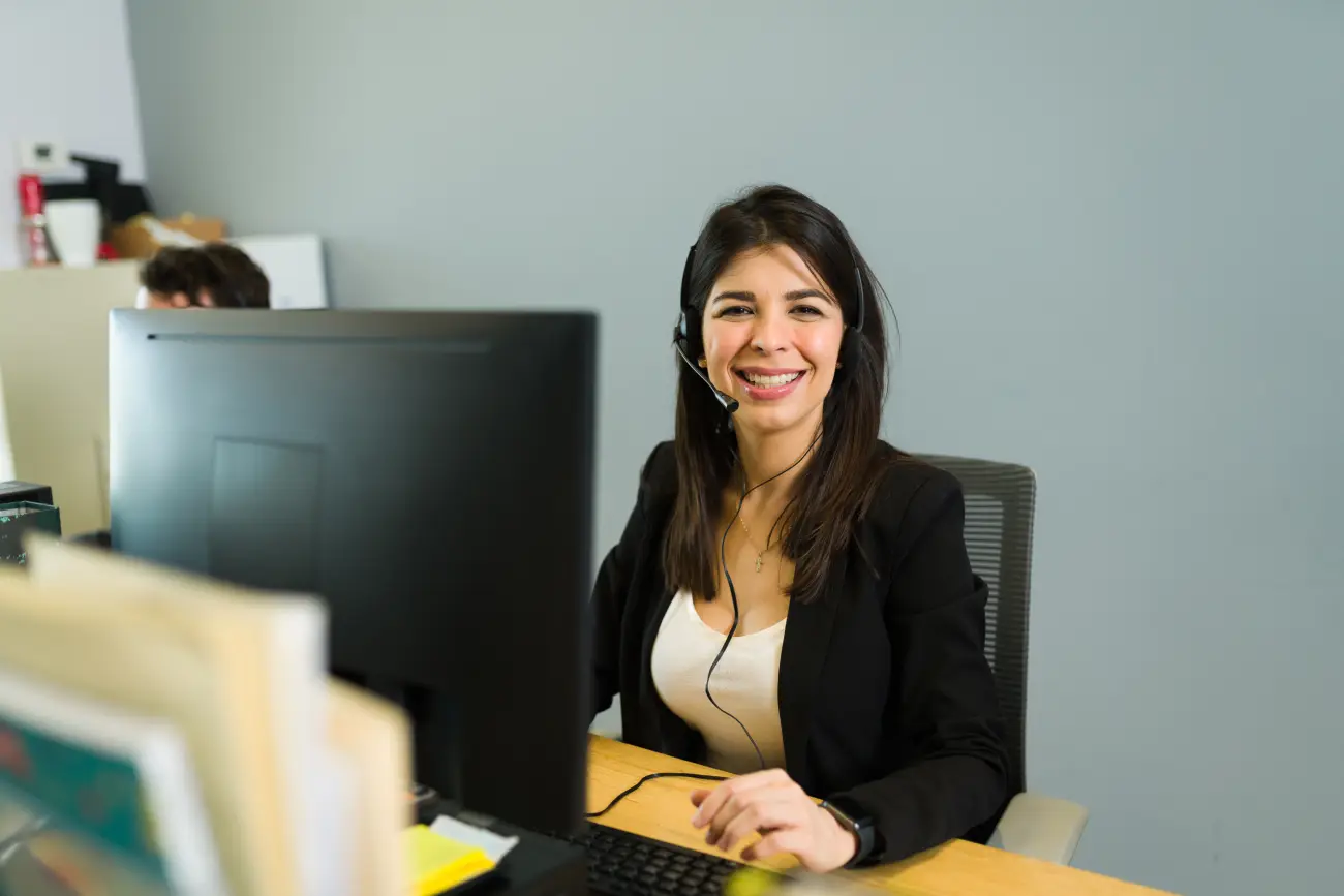happy-female-call-center-agent-with-headset-receiving-calls-unified-voice