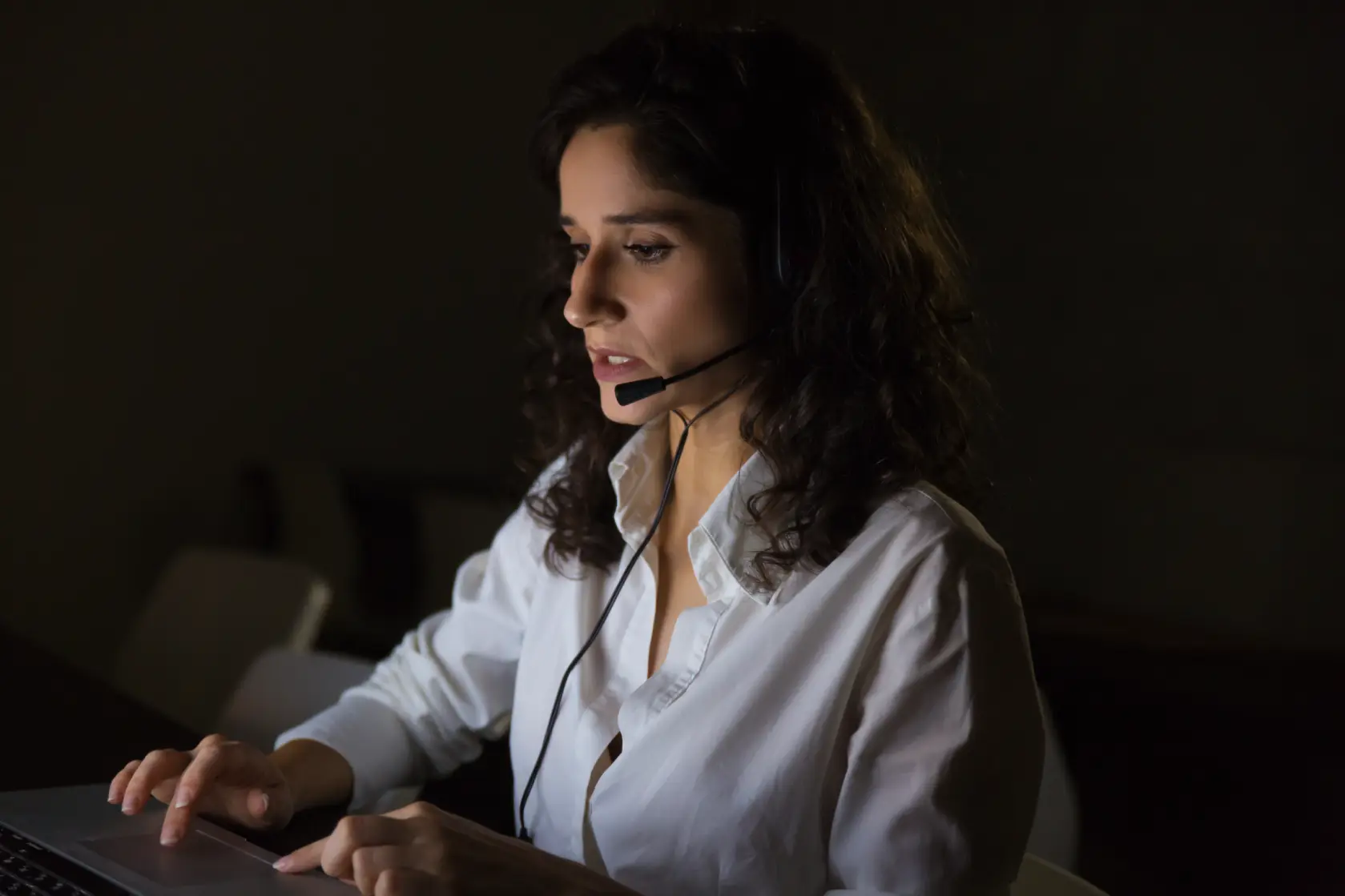 serious-call-center-operator-in-dark-office-unified-voice