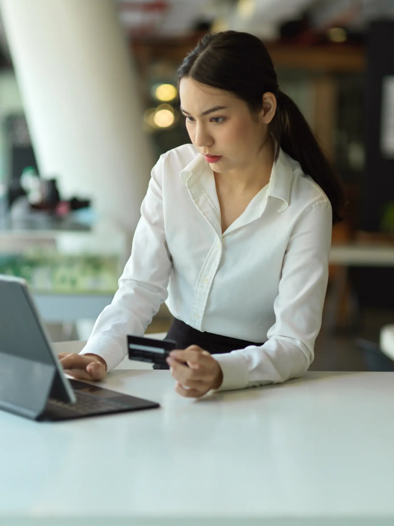 woman-using-mobile-phone-while-sitting-at-table-unified-voice