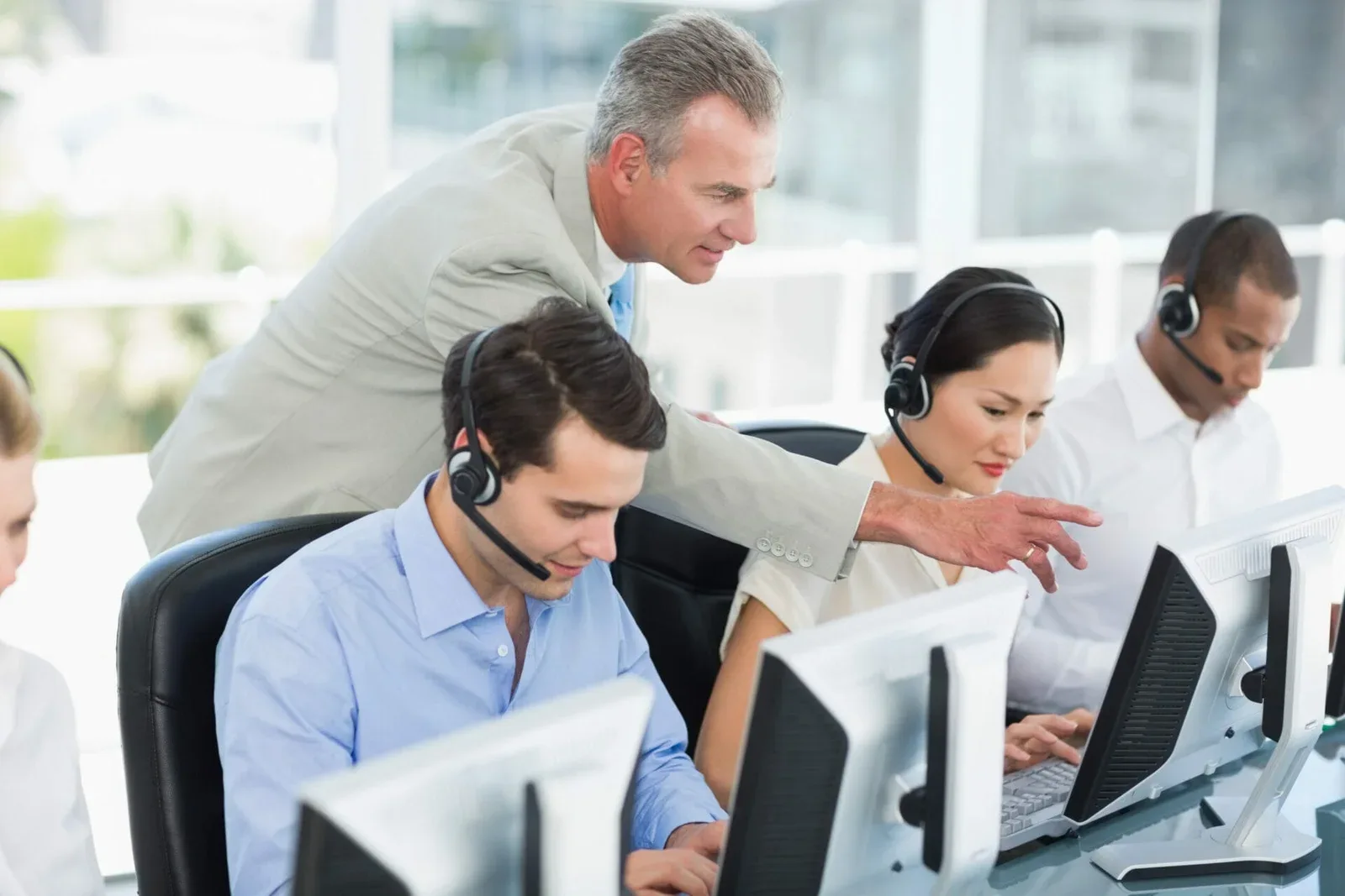 manager-looking-executives-with-headsets-using-computers-office-image-unified-voice